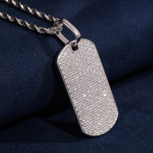 Iced Out Dog Tag Pendant three-quarter angle showing sparkle on dark navy suede