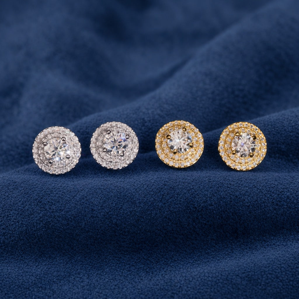 Four Double Halo stud earrings in silver and gold on navy suede