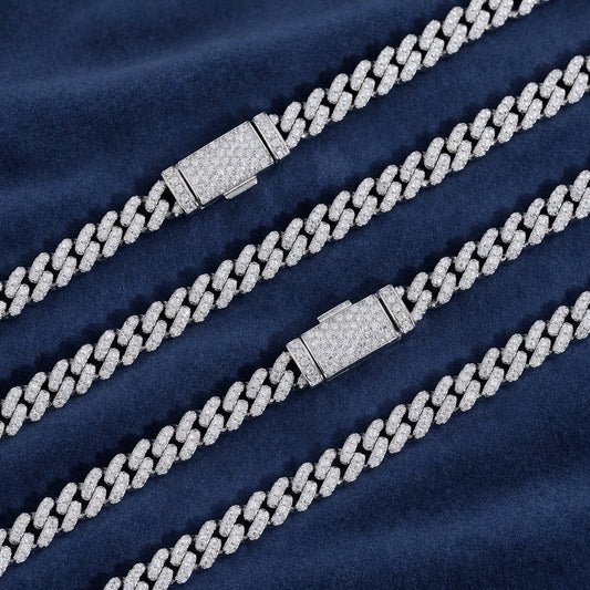 6mm iced Cuban link chains in 925 silver laid across navy suede, box clasps visible