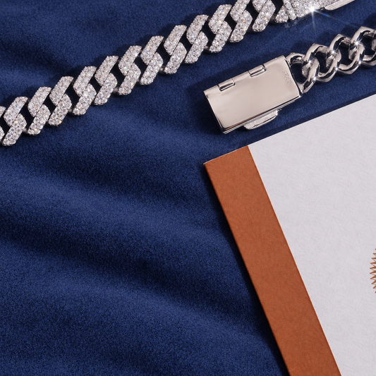 10mm Miami Cuban Bracelet in 925 silver laid on navy suede beside its GRA moissanite report