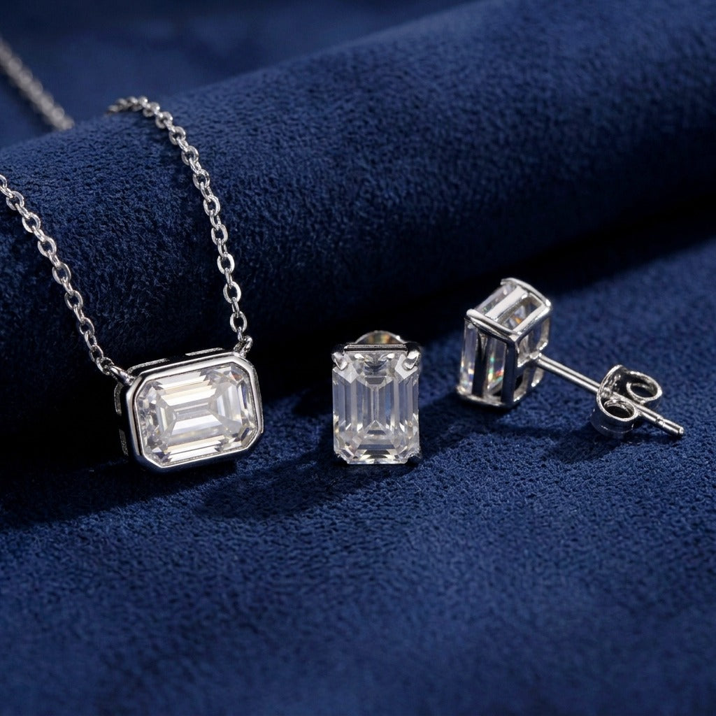 Emerald Cut Set detail, bezel-set pendant and stud earring post on navy suede