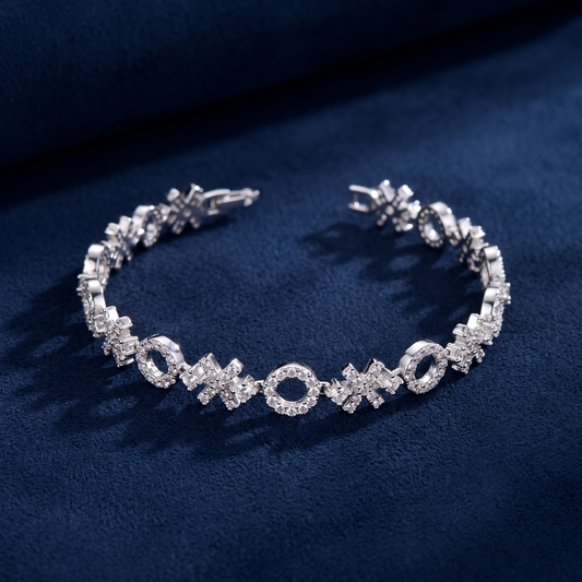XOXO Link Bracelet open flat-lay on dark navy suede