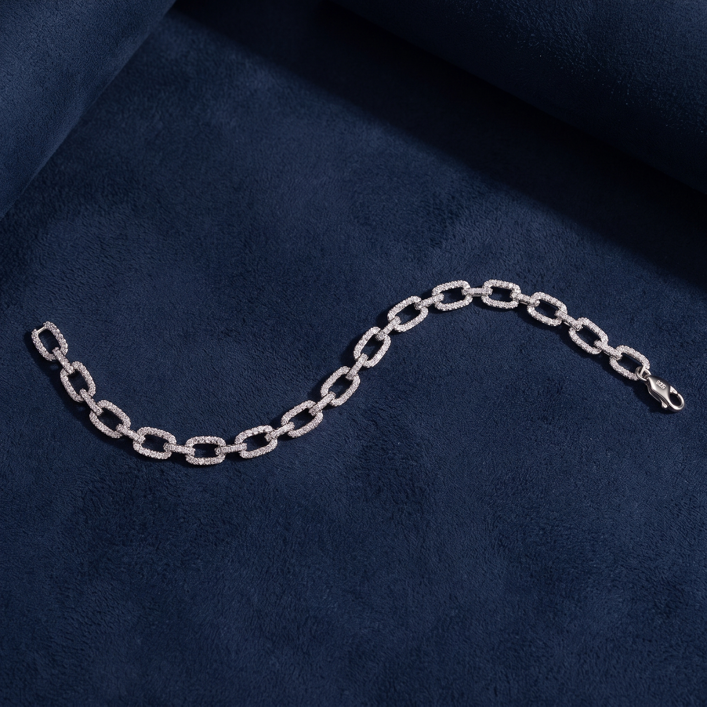 Infinity Link Bracelet showing 925 silver hallmark stamp on clasp, dark navy suede