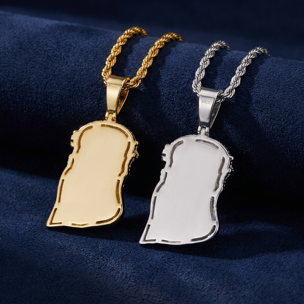 Back view of gold and silver Jesus piece pendants showing S925 hallmark, on navy suede