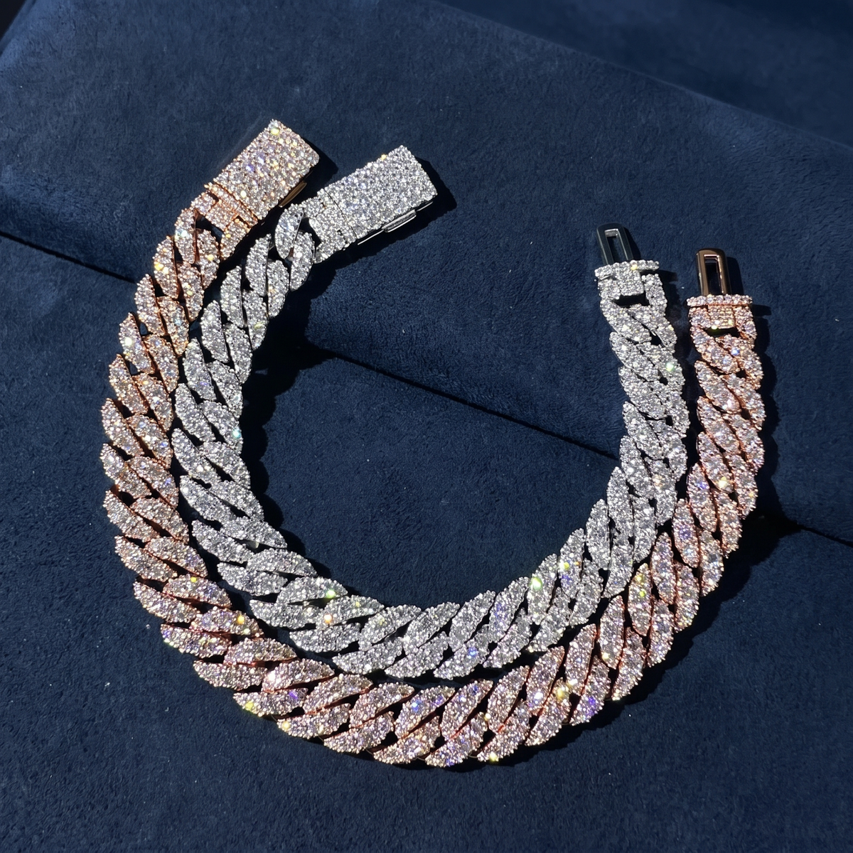 10mm Moon Rock Cuban bracelets coiled on navy suede showing prong-set marquise clusters